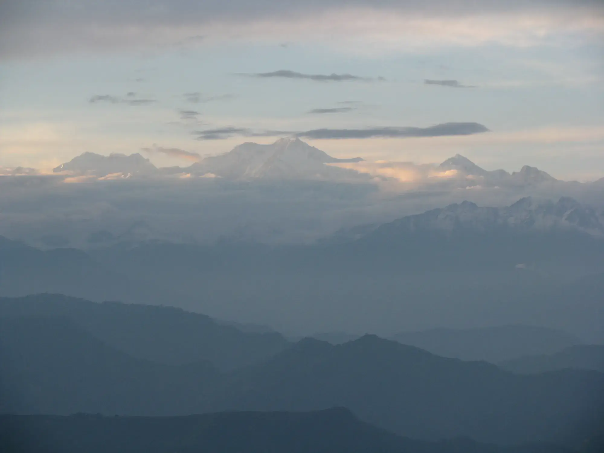 Kanchenjunga rising above the hills at dusk