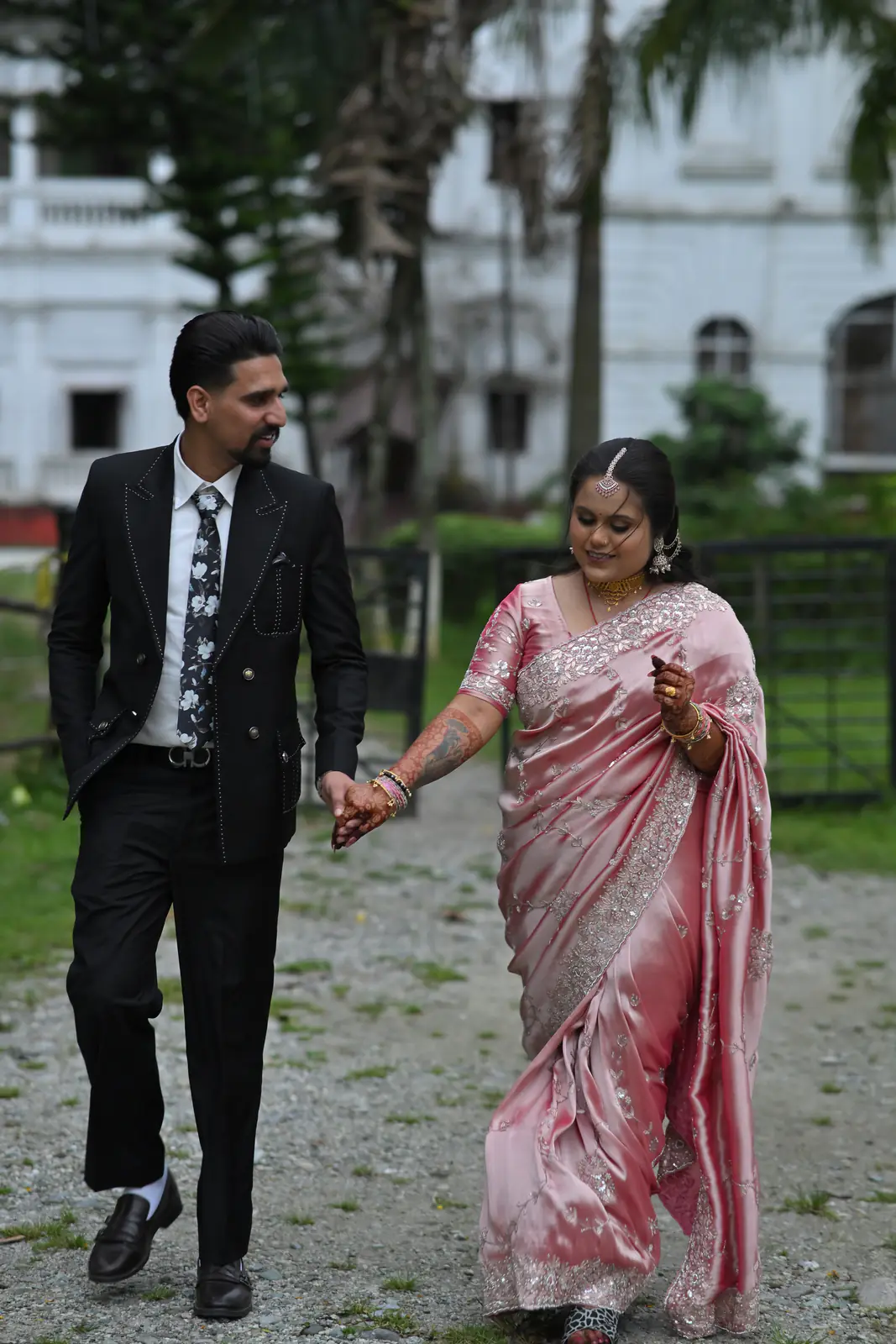 Manisha and Sumit walking hand in hand, laughing