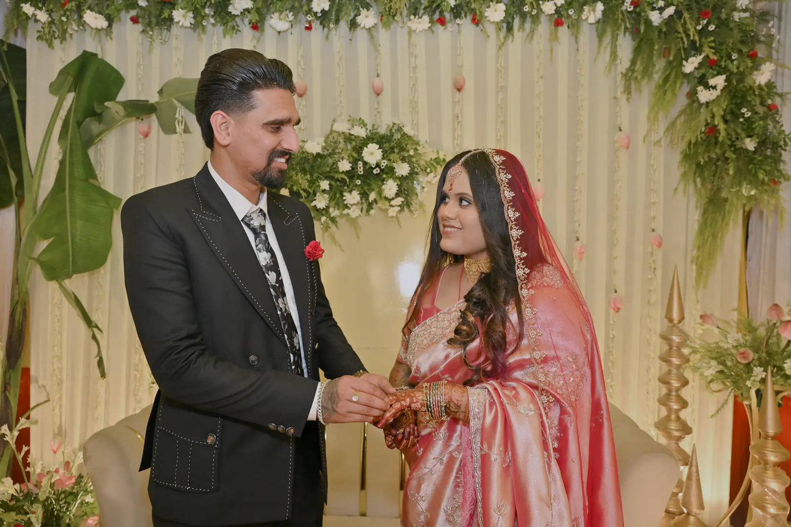 Sumit placing the ring on Manisha's finger at their engagement