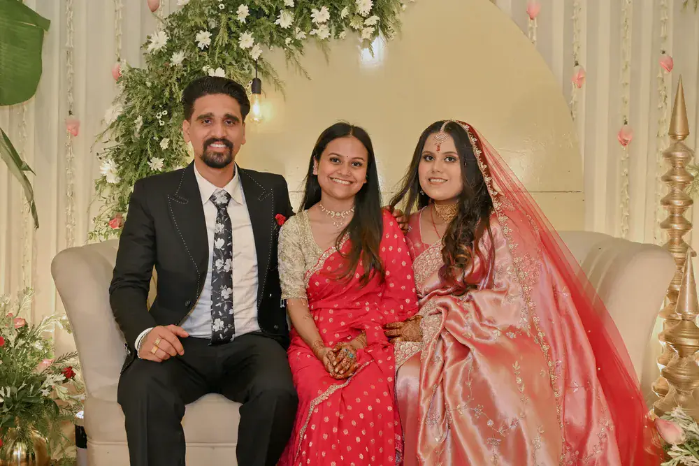 Manisha and Sumit on the stage sofa with a guest
