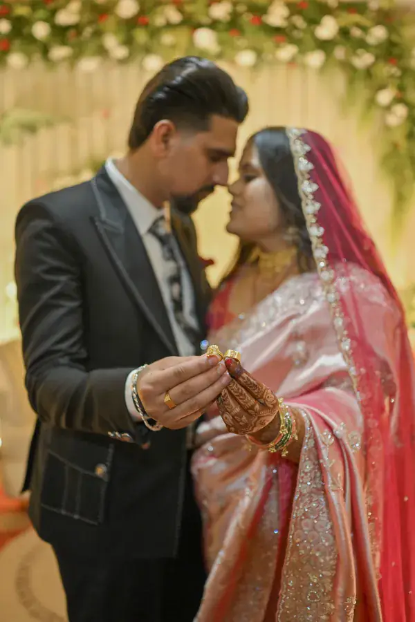 Manisha and Sumit looking at the ring together