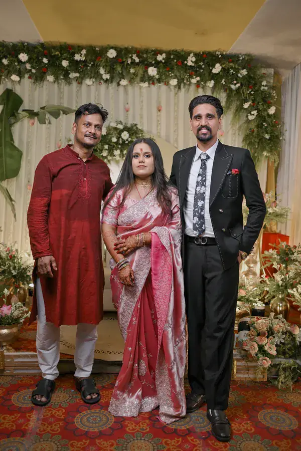 Manisha and Sumit with a guest before the floral stage