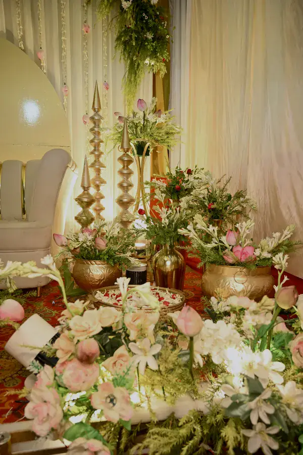 Lilies and tall brass finials beside the stage seating