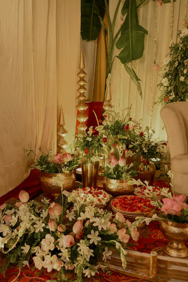 Lilies and brass urns at the corner of the stage