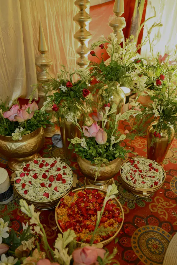 Brass urns and petal platters beneath tall finials