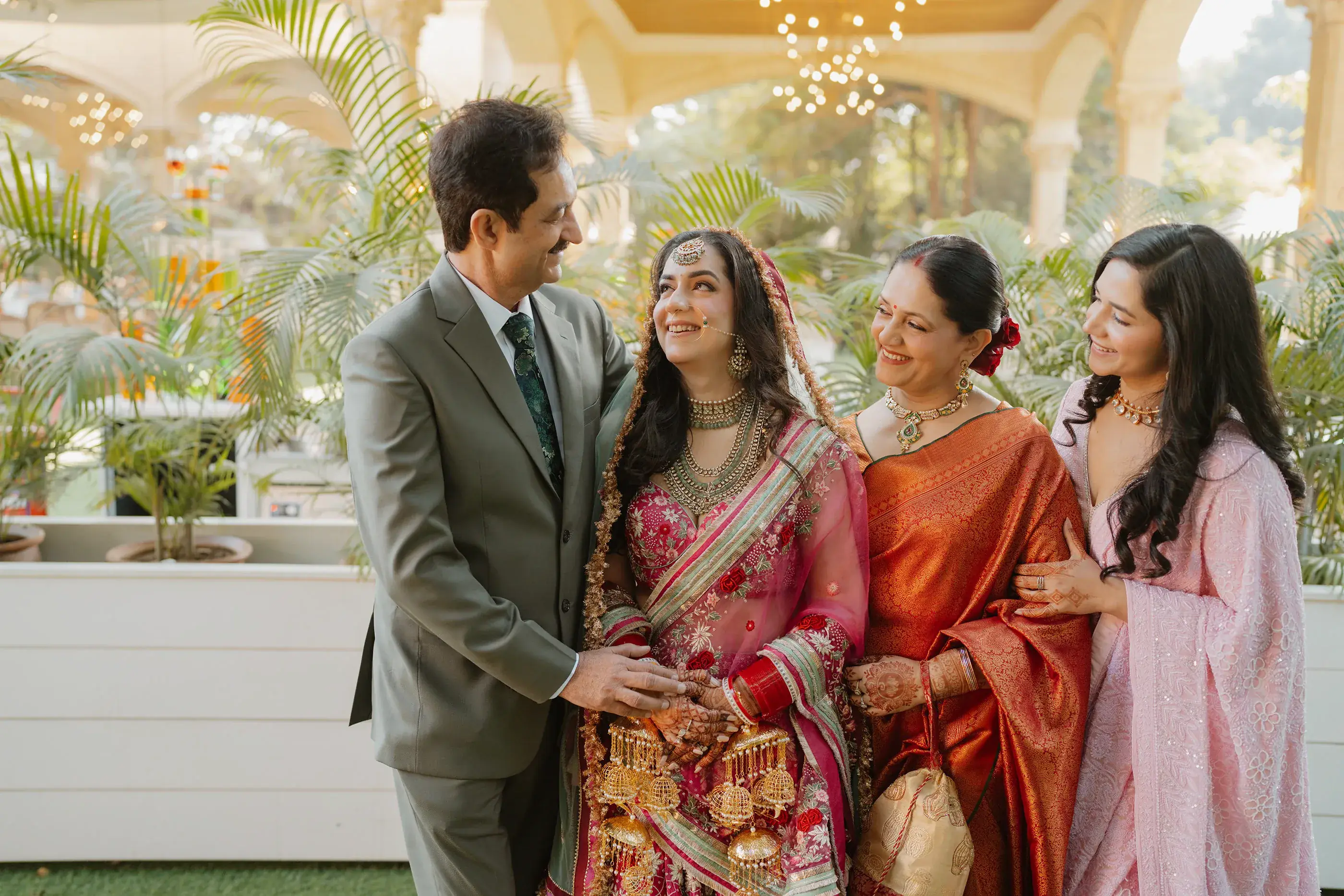 A bride with her family, smiling together on the wedding day