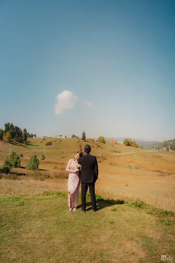 Sagar and Pritika walking across an open meadow